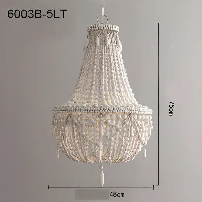 A delicate white french country wood bead chandelier with cascading strands and central pendant for bedroom or dining room