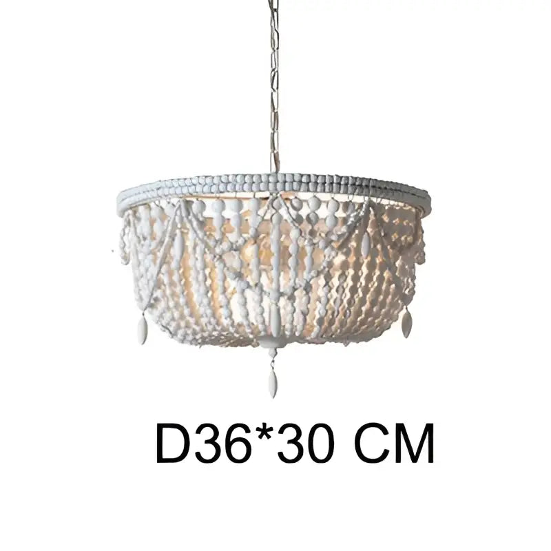 Delicate two-tiered french country wood bead chandelier with distressed white finish and cascading glass beads for dining room