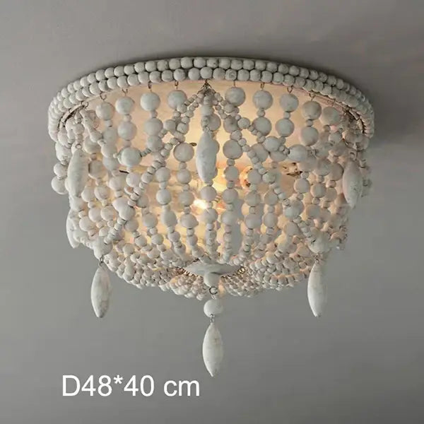 White french country wood bead chandelier with layered cascading design and teardrop ornaments for bedroom or dining room