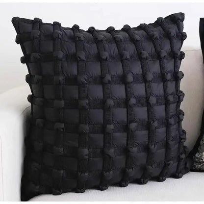 Black quilted cushion cover with textured grid pattern and pom-pom accents from decorbites french cream bubble collection