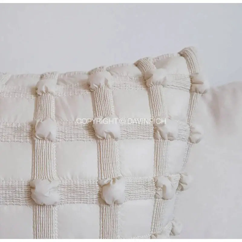 Cream-colored quilted french cream bubble cushion cover with textured grid pattern and subtle vertical stitching for living room decorbites decor