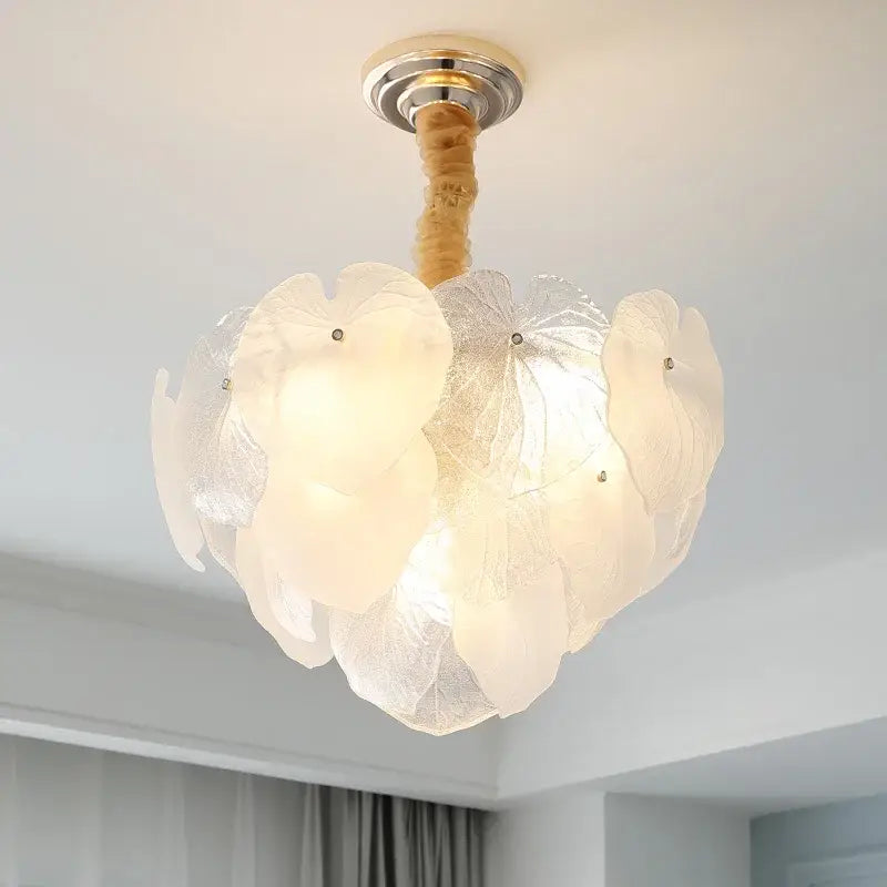 Delicate french cream crystal chandelier with translucent white petal glass shades and gold-toned metal mount for living room decor