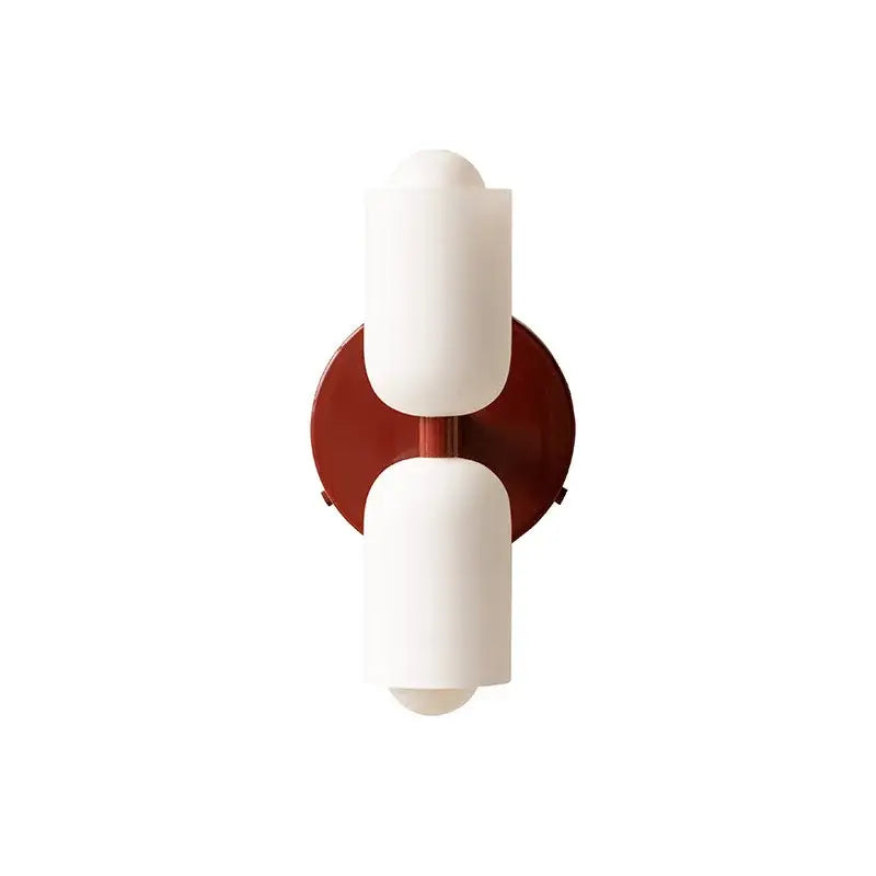 Modern french cream double headed wall lamp with off-white matte glass shades mounted on rust-colored backplate by decorbites