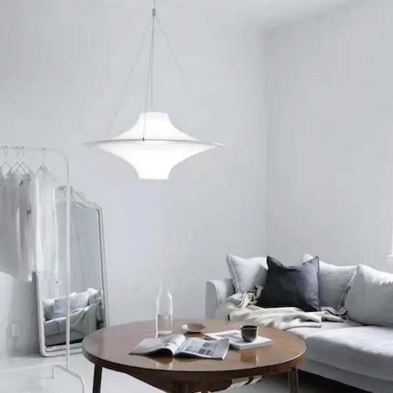 A sleek white ceramic pendant with disc-shaped design illuminates dining room decorbites french cream chandelier