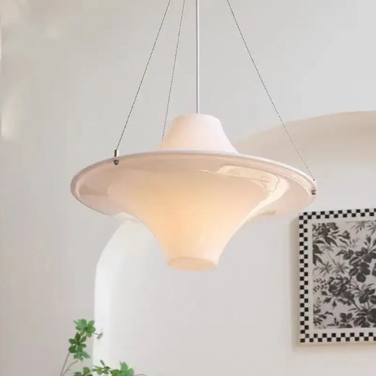 A cream modern chandelier featuring a white ceramic pendant with a sleek flared design and thin metal chains for dining rooms decorbites french cream