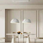 Two elegant french cream style led pendant lights with ornate domes hang above a minimalist dining table decorbites french cream