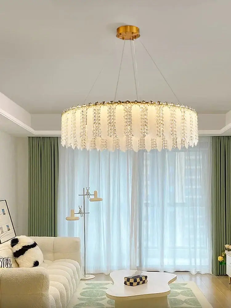 A decorbites french cream wind crystal chandelier with gold-toned mount and illuminated white diffuser pendant light