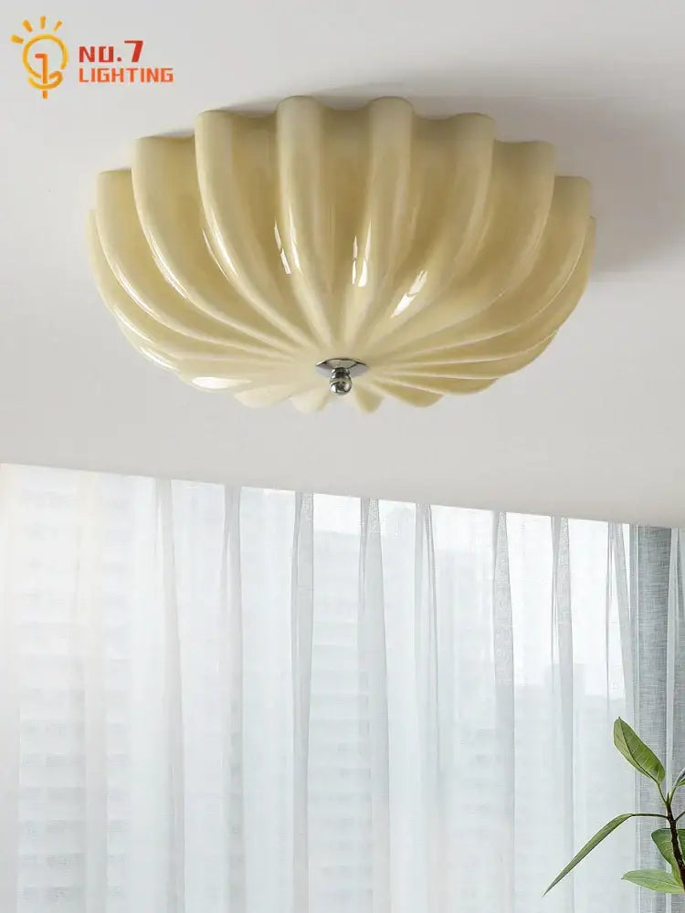 Cream-colored glossy ceramic ceiling lamp with fluted shell design for bedroom decorbites cream wind collection