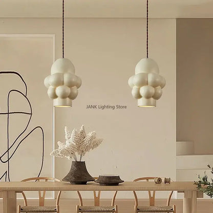 Off-white creamy wind led cloud pendant light with matte textured surface hanging from dark cords for dining room decorbites french creamy
