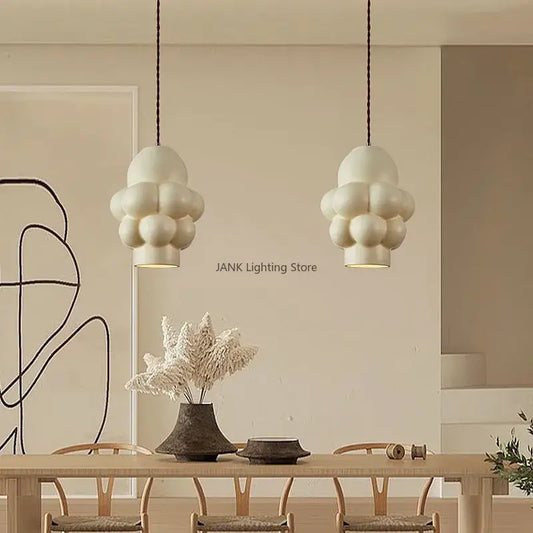 Off-white creamy wind led cloud pendant light with matte textured surface hanging from dark cords for dining room decorbites french creamy