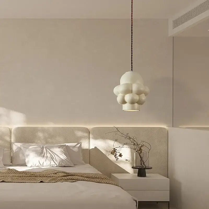 A modern white cloud-shaped decorbites french creamy led pendant light with a textured matte finish for dining room decor