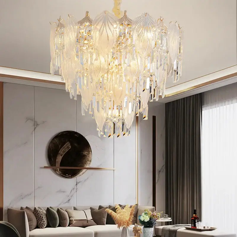 A french crystal chandelier pendant light with tiered clear and frosted glass leaves on gold-toned arms