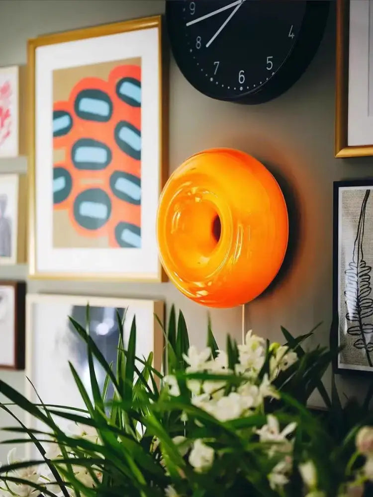 Vibrant orange translucent glass wall lamp with sleek donut shape for decorbites french decorative bedroom use