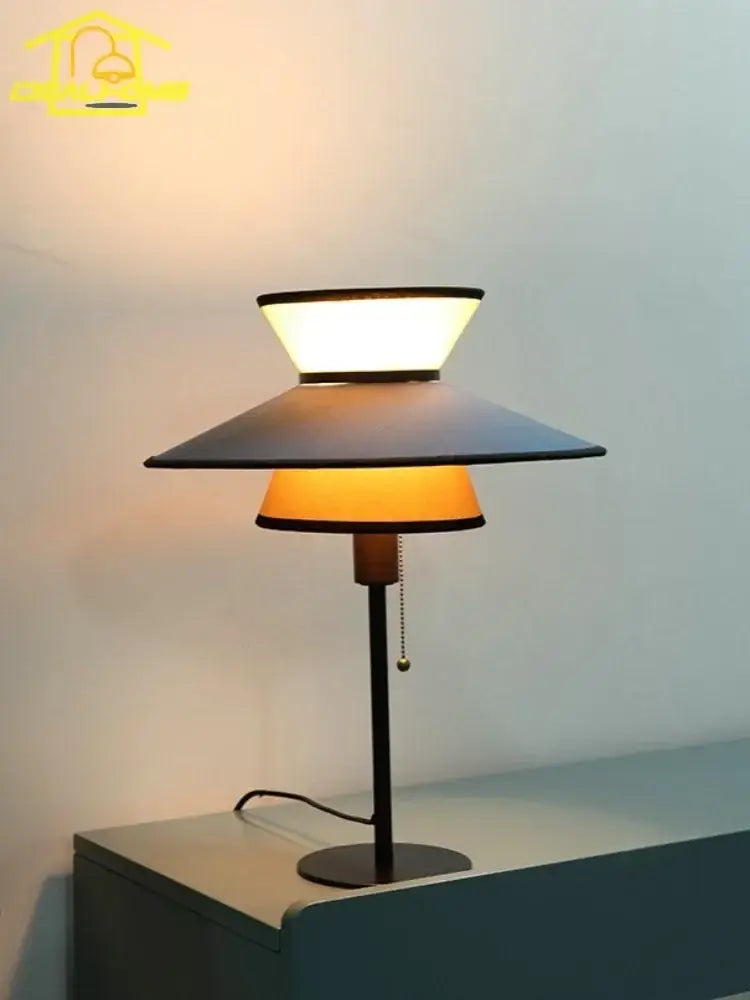 Black metal floor lamp with tiered conical shades emitting warm and cool light decorbites french design vertical style