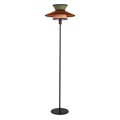 A decorbites french design floor lamp with slender black metal pole and stacked olive, terracotta, and beige shades
