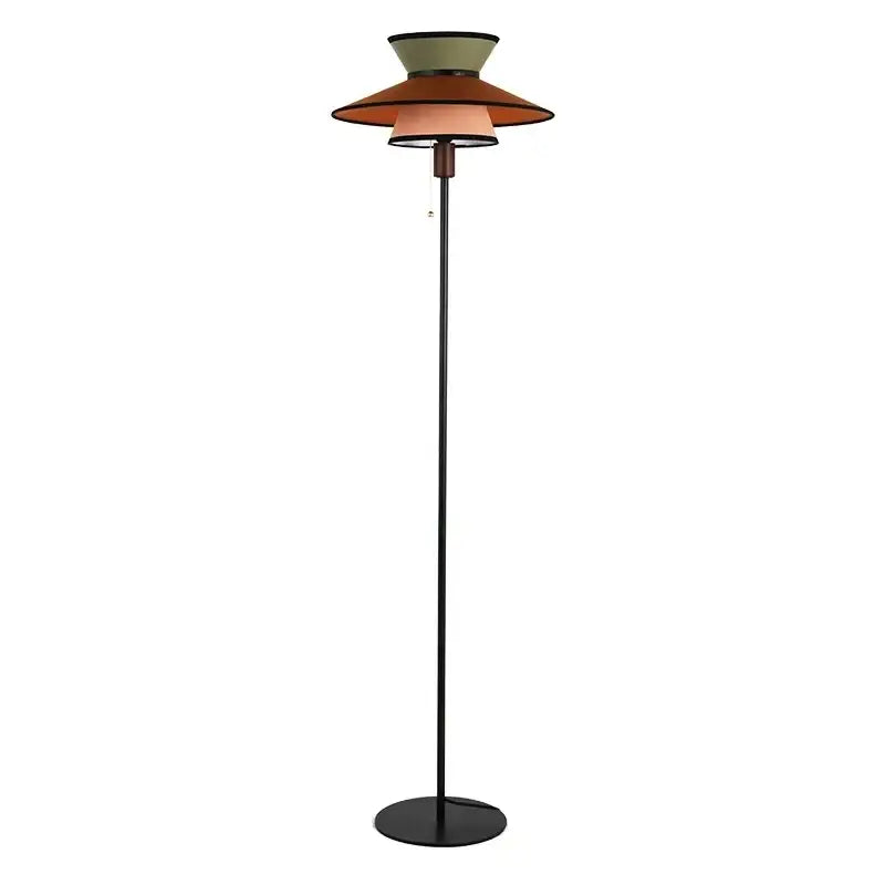A decorbites french design floor lamp with slender black metal pole and stacked olive, terracotta, and beige shades