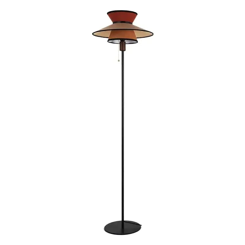 A sleek black floor lamp with a tiered amber shade featuring concentric circles from decorbites french design