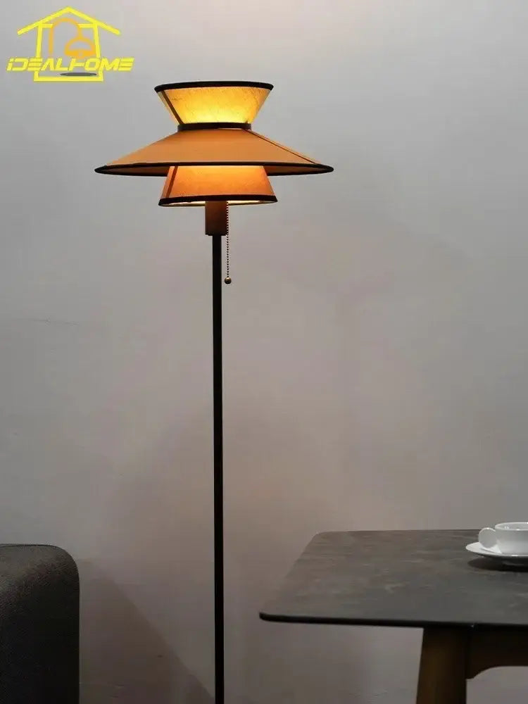 Warm-toned decorbites french design floor lamp with slender black metal pole and layered amber glass shades for living room