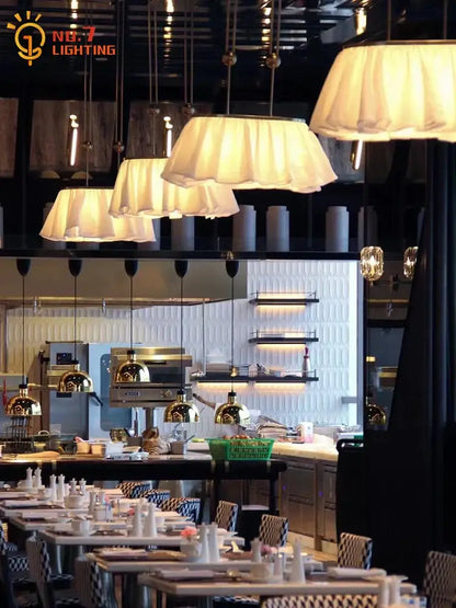 Cream-colored pleated fabric pendant lights with metallic fixtures for dining room decorbites french design led