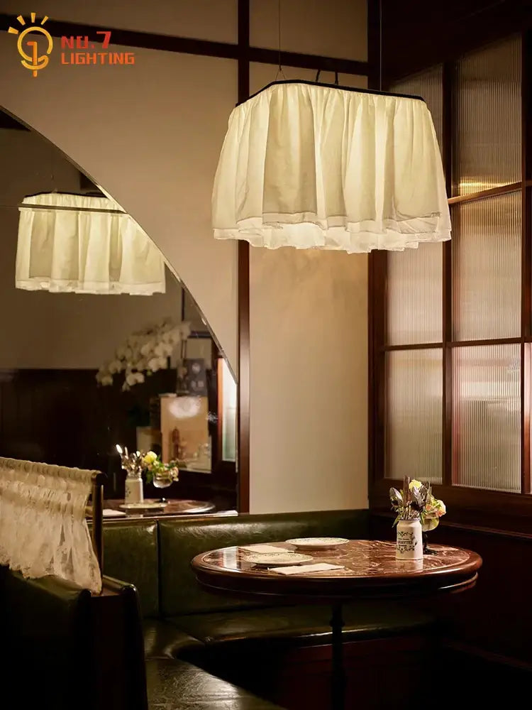 Cream-colored ruffled fabric pendant light with black trim by decorbites french design for dining room lighting