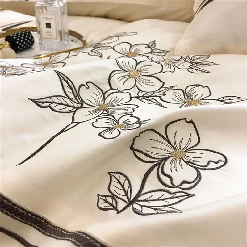 Cream-colored bedding set with delicate black and gold floral embroidery in decorbites french embroidered cotton style