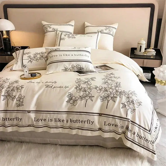 Cream-colored french embroidered cotton bedding set with black floral decor and love is like a butterfly borders