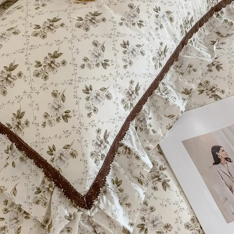 Cream-colored pillow sham with delicate gray floral pattern and brown lace trim from decorbites french floral bedding set