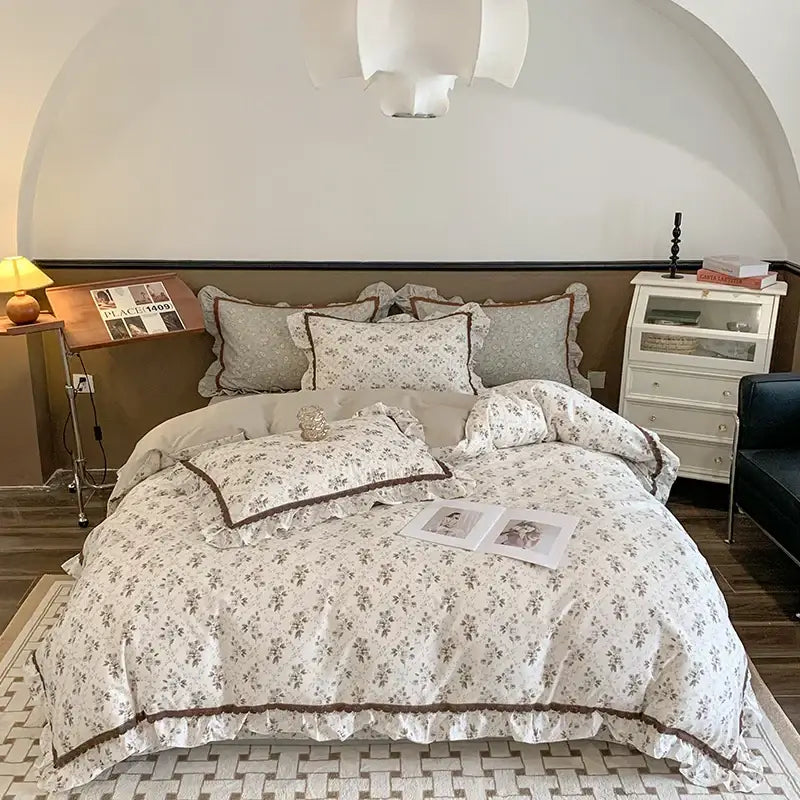 Cream-colored bedding set with delicate ruffled edges and brown trim from decorbites French floral bedding collection