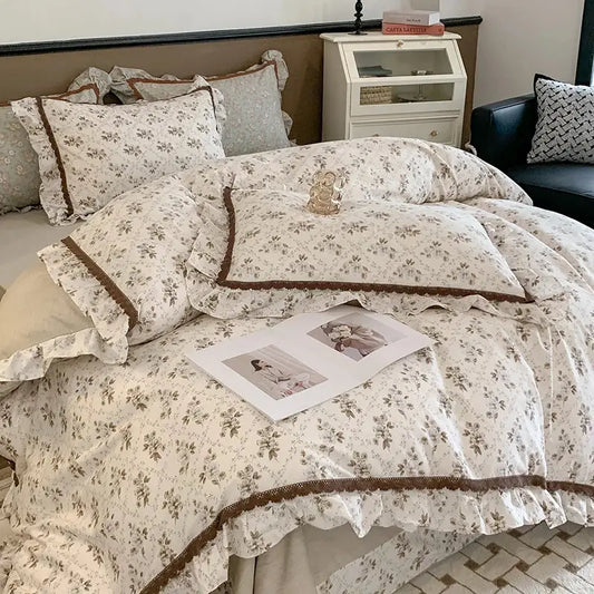Cream-colored bedding set with delicate brown ruffled trim and lace detailing from decorbites french floral collection