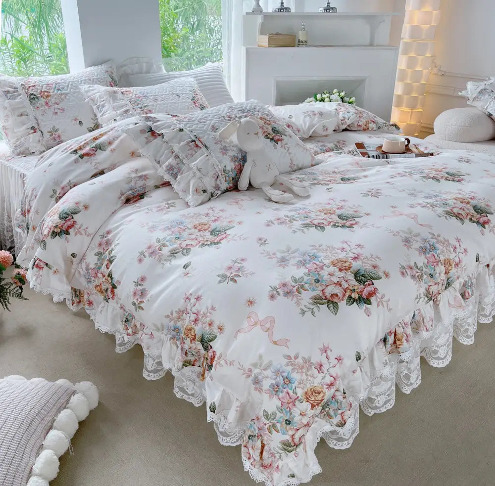 A delicate white bedding set with ruffled lace trim and soft pastel blossoms featuring decorbites french floral print