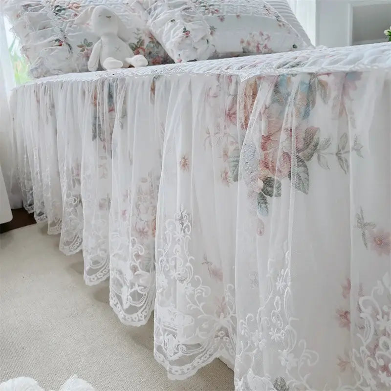A delicate white lace bed skirt with floral embroidery and ruffled edges in decorbites french floral bedding set