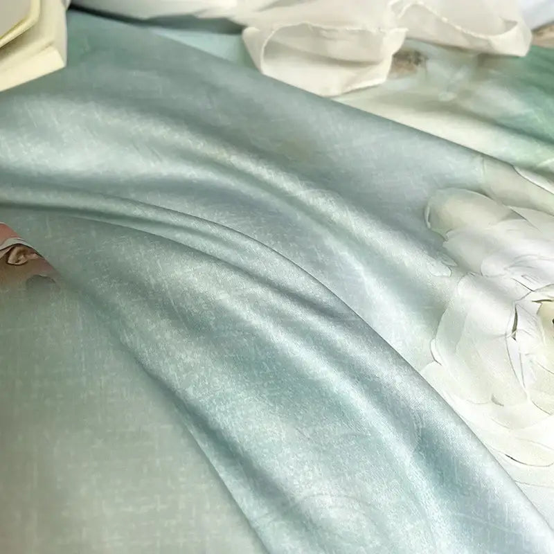 A soft light blue satin bedding set with delicate floral embroidery and lace ruffles decorbites french flowers design