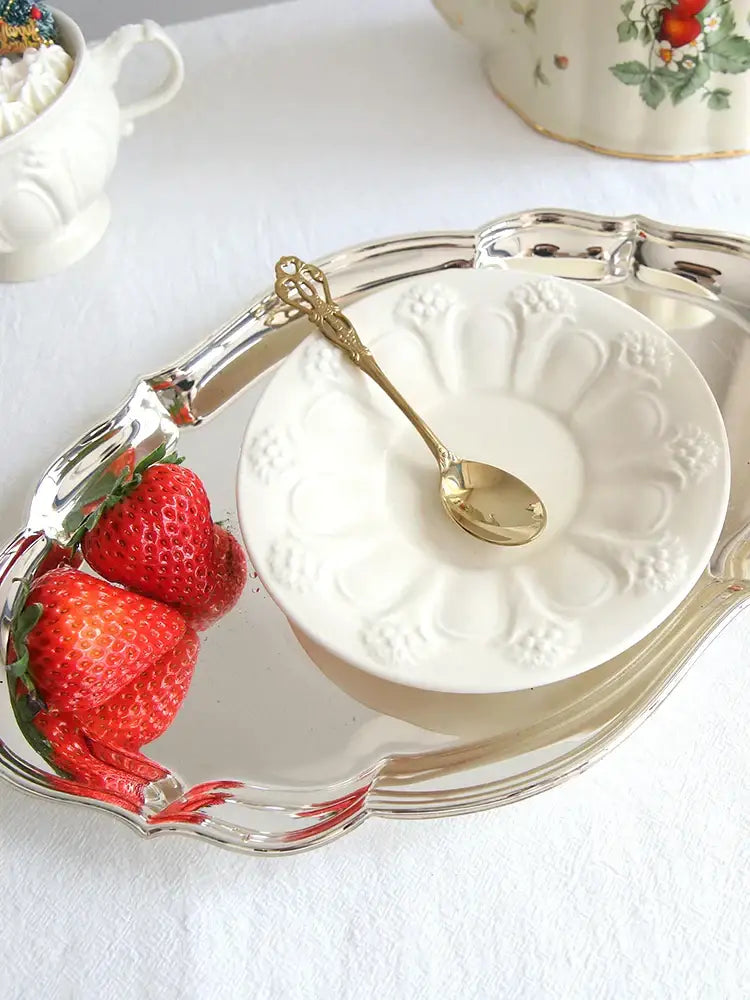 A decorative silver tray with scalloped edges holds a white ceramic bowl and fresh strawberries for decorbites french garden cream tea cup set