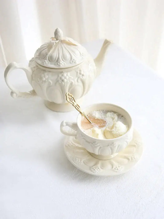 A delicate french garden cream porcelain tea cup with floral embossing and ornate gold spoon by decorbites french garden