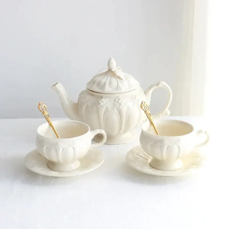 Elegant ivory porcelain teapot with ornate floral detailing and gold-accented lid in decorbites french garden cream tea cup set