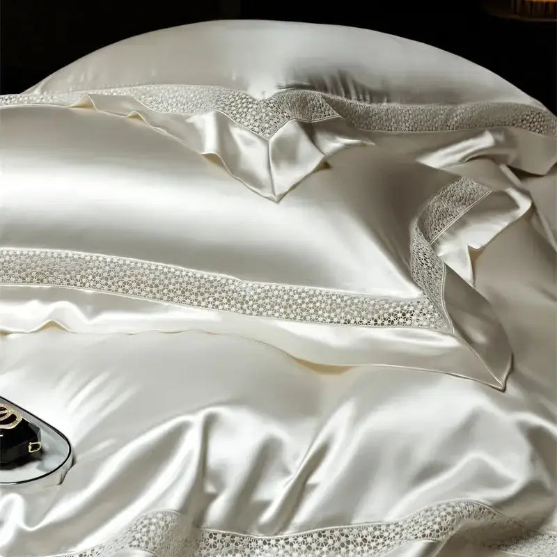 Cream-colored satin pillowcases with lace trim and shimmering embellishments in french hollow luxury bedding set decorbites