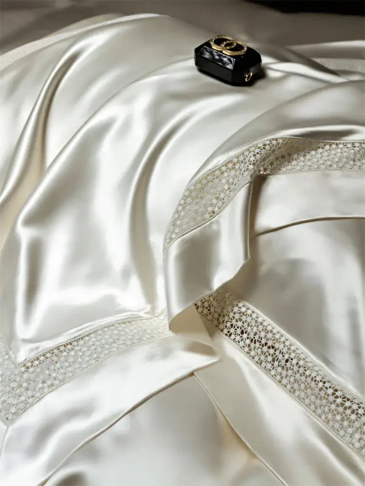 A sleek black Chanel clutch with gold interlocking cc and chain strap on cream satin lace for French hollow luxury decorbites bedding set