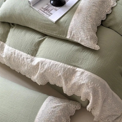 A delicate cream-colored lace trim with intricate floral embroidery adorns pillowcases in a french lace cotton mint green bedding set by decorbites