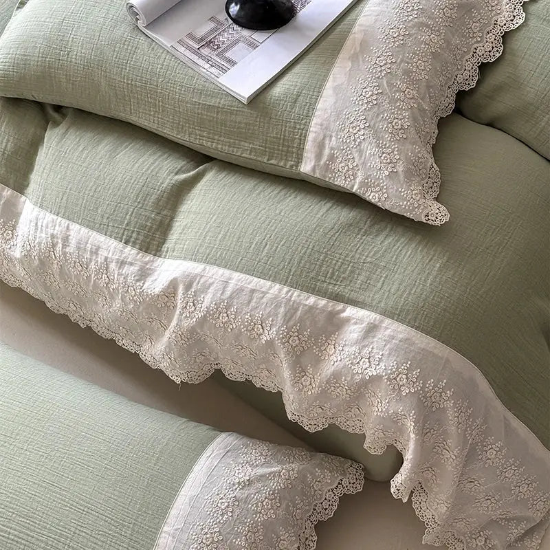 A delicate cream-colored lace trim with intricate floral embroidery adorns pillowcases in a french lace cotton mint green bedding set by decorbites