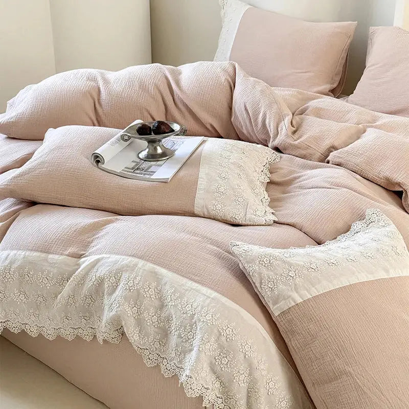 A soft blush pink linen duvet set with delicate white lace trim and floral embroidery from decorbites french lace bedding set