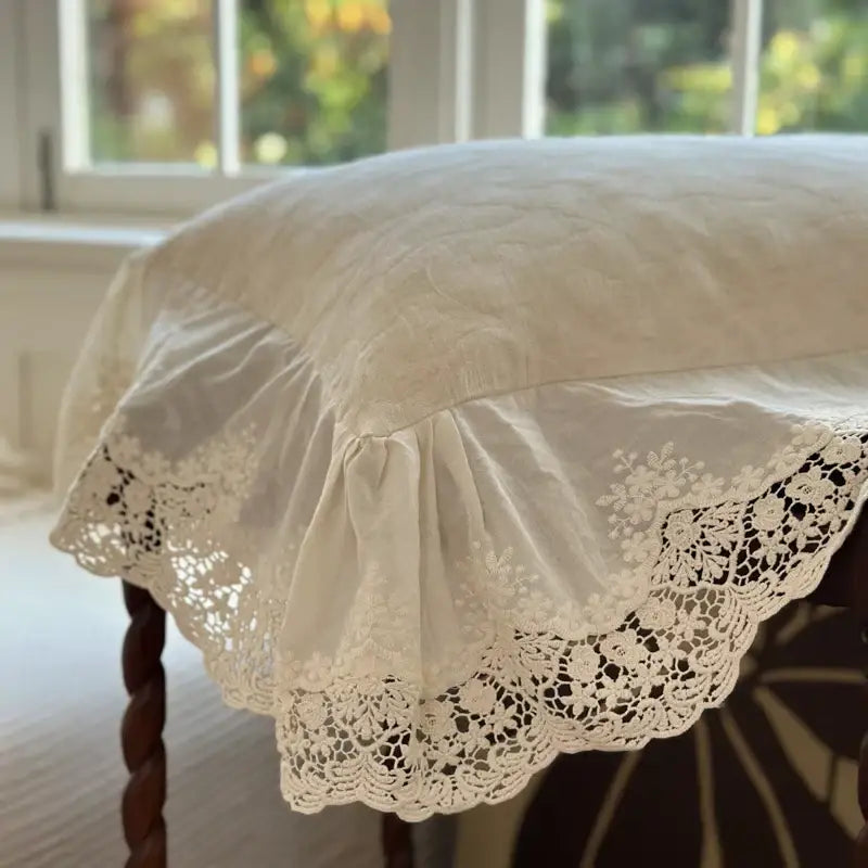 Cream-colored lace-trimmed pillow cover with floral embroidery and soft ruffle in jacquard linen cotton bedding set
