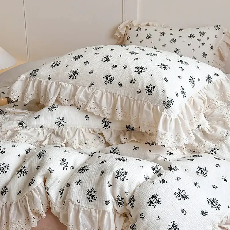 Cream-colored cotton pillowcases with black floral patterns and delicate ruffles in decorbites french lace floral bedding set