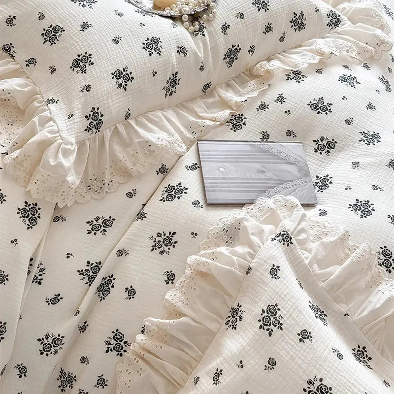 Cream-colored cotton bedding set with black rose patterns and delicate lace ruffles from decorbites french lace floral design
