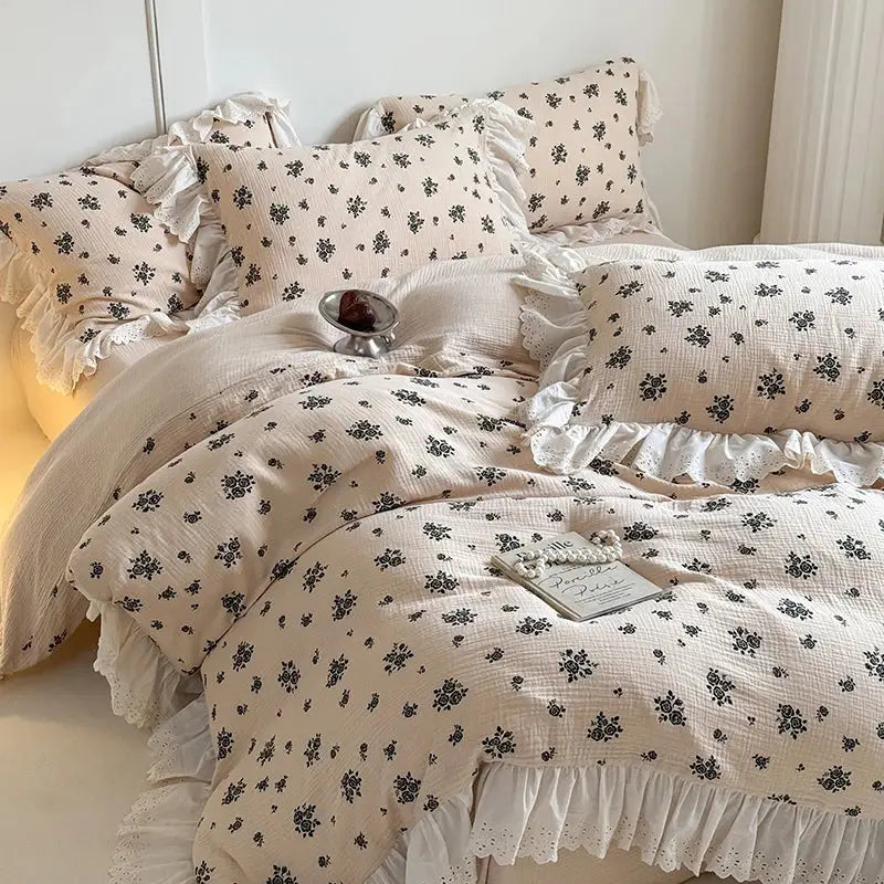 Cream-colored cotton bedding set with delicate black floral prints and lace-trimmed ruffles decorbites french lace floral