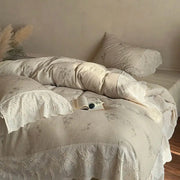 Cream-colored cotton bedding set featuring delicate french lace flowers embroidery and lace trim for bedroom use