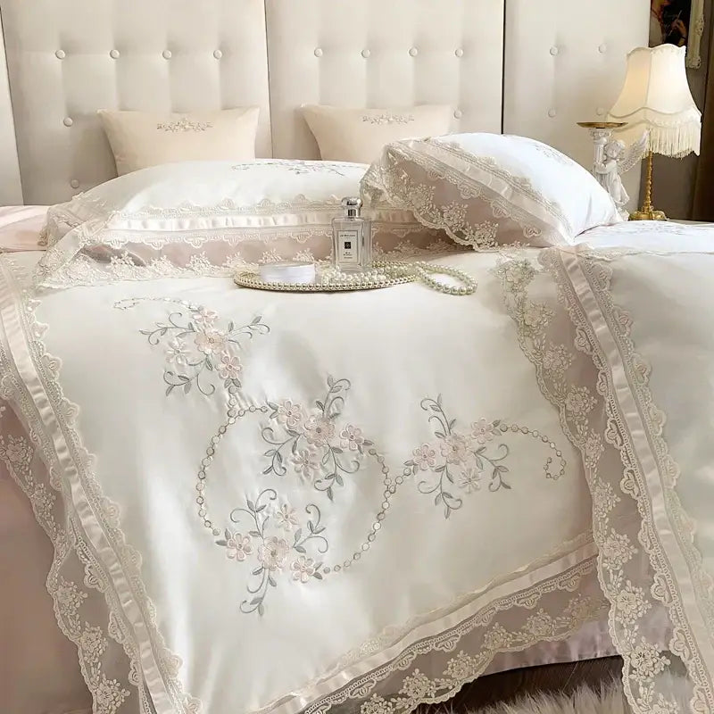 Cream-colored satin bedding set with delicate floral embroidery and lace trim from decorbites french lace flowers collection