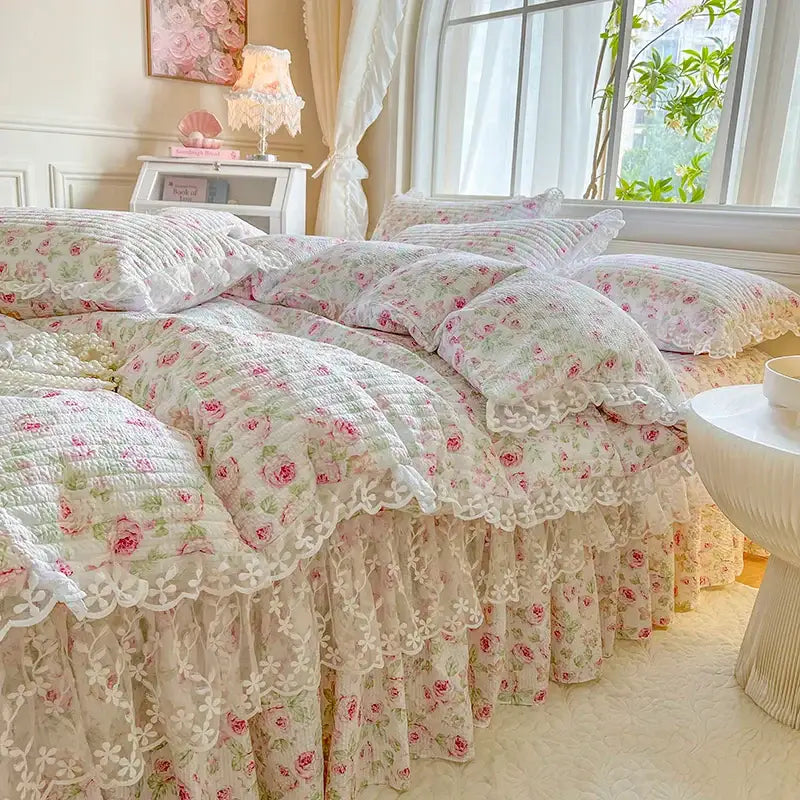 A delicate ivory quilted bedding set with pink rose floral patterns and french lace ruffles decorbites french lace