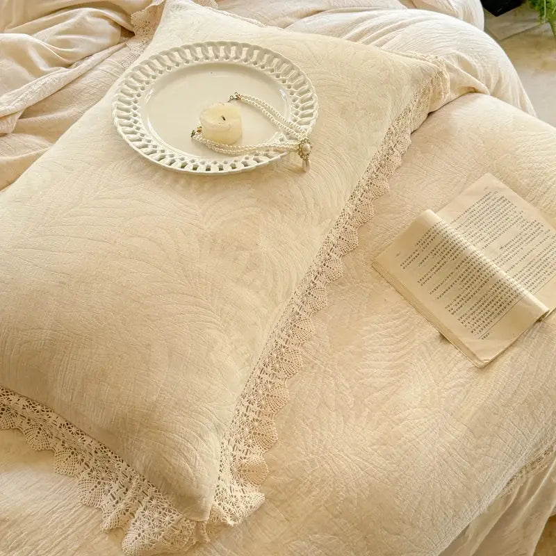 Cream-colored pillow with delicate french lace ruffles and subtle textured linen fabric from decorbites bedding set