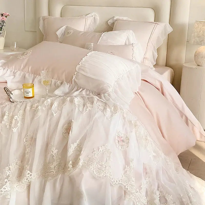 A delicate pink and white cotton bedding set with french lace ruffles embroidered floral details for decorbites french lace