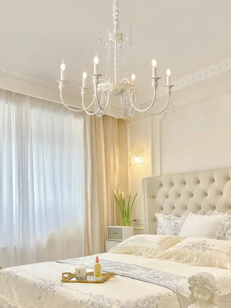 A delicate white crystal chandelier with ornate arms and candle bulbs for living room decorbites french light luxury